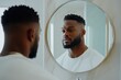 © nabila - black Man looking at his self in the mirror. fresh cut hair and hairline, bearded men, with copy space