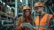 © Attasit - Foreman showing progress updates on a clipboard to the engineering manager and project consultant, all in reflective vests and safety helmets catch the eye.