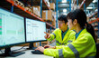 © Reubens Stock Photos - Japanese Logistics Team Analyzing Inventory Data on Dual Monitors in a Warehouse Setting