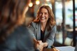 © Kevin - Happy mid aged business woman manager handshaking at office meeting. Smiling female hr hiring recruit at job interview, bank or insurance agent, lawyer making contract deal with client, Generative AI