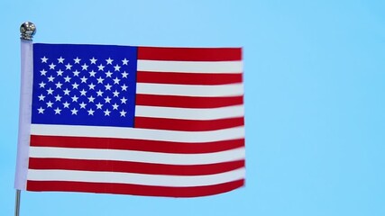 Wall Mural - American flag waving on blue background, slow motion