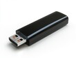 © Nattapoom - A black USB drive on a white background