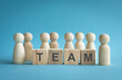 © sinseeho - Team, word on wood blocks with people figures. To illustrate team or people resources in organization.