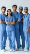© Hitesh - Group portrait of four indian asian young doctors in uniform standing against white background, Generative AI