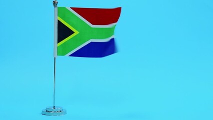 Wall Mural - Slow motion video of South Africa flag waving on blue background