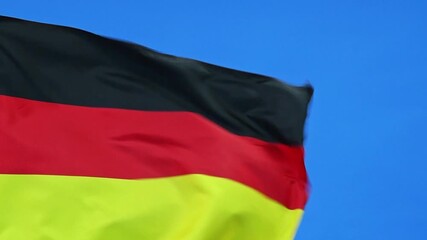 Wall Mural - Slow motion video of Germany flag waving on blue background