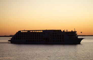 Wall Mural - Lake Nasser cruise ship from Abu Simbel to Aswan at sunset, Egypt