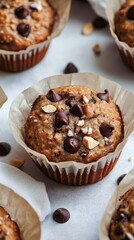 Wall Mural - A muffin with chocolate chips and nuts sits on a table