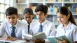 © N7 - A group of Indian high school students studying or researching in a library setting.