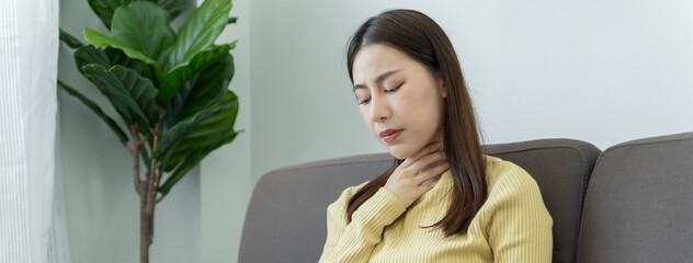 Wall Mural - woman touch her neck and feeling a sore throat