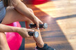 © puhimec - Pregnant woman in the gym sits on a fit ball with dumbbells.