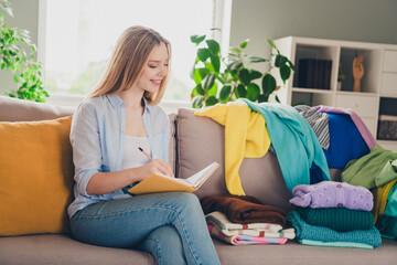 Wall Mural - Photo of pretty cheerful lady wear casual shirt writing clothes checklist indoors room home house