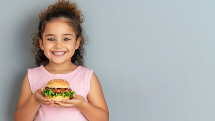 Canadian little girl smile holding hamburger fast food for student lunch