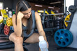 © puhimec - Pregnant woman in the gym with water. Sports and healthy lifestyle.