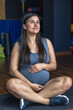© puhimec - Pregnant woman in the gym doing warm-up. Sitting on a yoga mat.