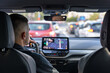© puhimec - Man touching screen of a GPS navigation system in his car.
