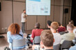 © Anton Gvozdikov - Group of people seated in lecture hall attentively listening to presentation by speaker. Educational environment promotes learning and engagement.