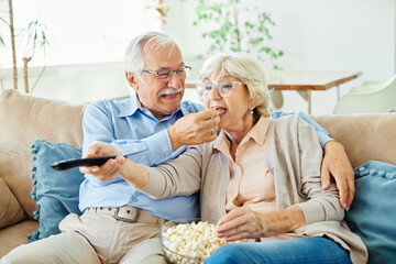 Wall Mural - television watching senior couple tv home woman man remote movie mature old aged active vitality eld
