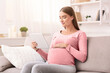 © Prostock-studio - Content Pregnant Woman Using Digital Tablet Computer Reading E-Book Relaxing Sitting On Couch At Home
