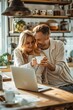 © Dzmitry Halavach - A couple enjoys a tranquil morning sharing coffee and laughter in their cozy kitchen