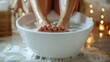 © Thanthara - Woman, soaking feet in warm water in white basin, home background