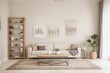 © HEKOLA - A living room with a white couch, coffee table, and a potted plant