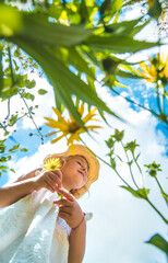 Poster - Children in the park with flowers summer. Selective focus.