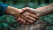 © Рудой Максим - Two individuals shaking hands in a forest setting during daylight