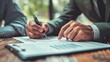 © Рудой Максим - Business professionals engaged in discussion while reviewing financial documents at a wooden table during the day