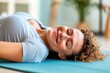 © Tetiana - happy girl coach lying on fitness mat