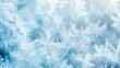 © Boinah - Close-up of delicate snowflakes on a soft blue background, showcasing winter beauty.
