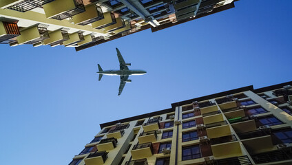 plane flies low over houses