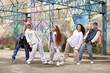 © New Africa - Group of people dancing hip hop outdoors