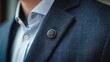 © Leopard - a close up on a person wearing a suit with a magnetic round pin on the shirt.
