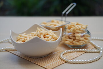 telur gabus sticks in bowl and jar on wooden table background.