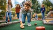 © Sasa Visual - A group of children cheerfully plays miniature golf in a park, focusing on their shots and enjoying the sunny afternoon