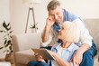 © Prostock-studio - Happy elderly couple searching film on digital tablet, resting at home on weekends
