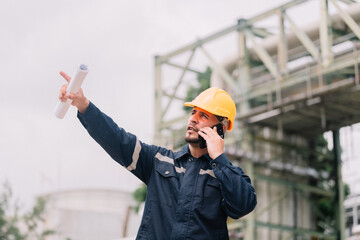 professional man workers engineer in construction industry uses a smartphone to discuss project updates on site. the integration of technology and effective communication in construction management.