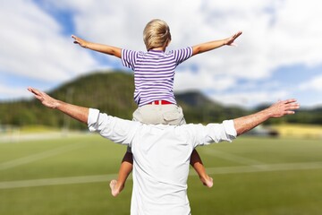 Poster - Happy father with small son on field at summer