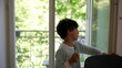 © Marco - Young boy reaching for the window knob, stepping out onto the balcony to explore, and returning home to close the window. curiosity and interaction with the outdoor environment