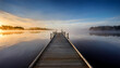 © Galeno - minimalist wooden pier extending misty lake sunrise reflective water surface atmospheric landscape create serene contemplative scene