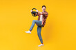 © ViDi Studio - Full body side view young shocked surprised happy man he wear red checkered shirt casual clothes hold steering wheel driving car isolated on plain yellow orange background studio. Lifestyle concept