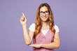 © ViDi Studio - Young happy successful employee business woman corporate lawyer wear white t-shirt vest glasses point index finger aside on area isolated on plain purple background studio. Achievement career concept.