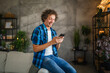 © Miljan Živković - happy relax adult caucasian man use mobile phone at home