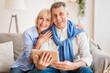 © Prostock-studio - Excited mature couple with digital tablet smiling to camera, woman embracing husband
