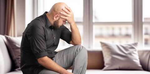 Portrait of upset depressed man in living room