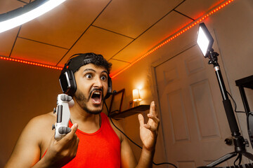 Adult man gamer wearing a headsets with scared gesture.