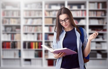 Canvas Print - Happy young student in library with books