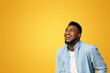 © Prostock-studio - Awesome sales. Ecstatic african american guy looking up at copy space with amazement, isolated on yellow background