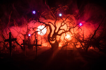 Wall Mural - spooky dark landscape showing silhouettes of trees in the swamp on misty night.